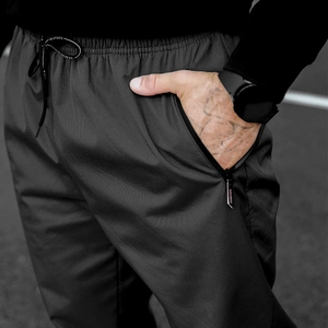 Detail of grey winter fleece trousers with elastic drawstring waist and zip pocket