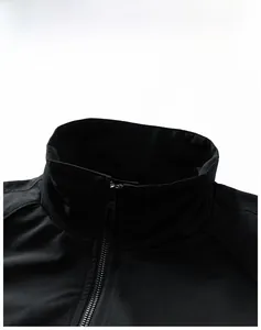 Close-up of stand-up collar design and metal zipper on black windproof outdoor jacket