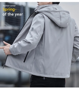 Detail of light grey hooded windbreaker featuring adjustable hood and sleek outdoor fabric