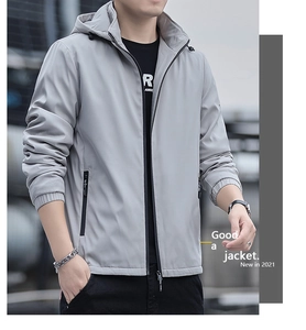 Detail of light gray windproof hooded jacket with black contrast zipper and elastic cuffs