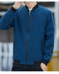 Detail of navy casual jacket featuring tropical leaf texture and black ribbed collar
