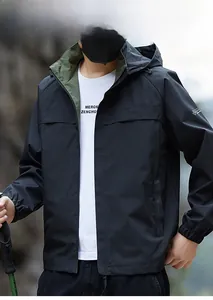 Detail of waterproof black outdoor jacket featuring contrast green lining and hooded design