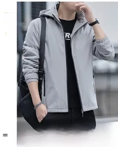 Detail of light grey windproof hooded jacket with elastic cuffs and zipper pockets