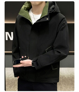 Detail of hooded jacket with green lining contrast and functional cargo pockets