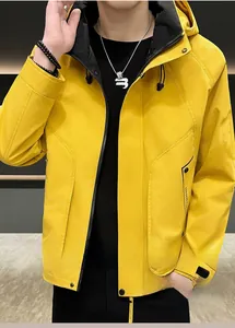 Detail view of yellow hooded windbreaker with black drawstrings and chest branding