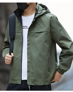 Detail of army green outdoor hooded jacket featuring functional zipper and elastic cuffs