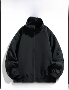 Flat lay of a black minimalist outdoor jacket with stand collar and elastic cuffs