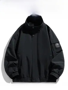 Detail of outdoor jacket showing logo patch on sleeve and stand collar zip closure