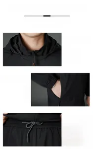 Detail of hood neckline, zipper pockets, and drawstring elastic waist on black sports suit