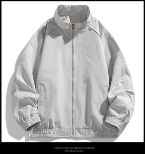 Detail view of light grey outdoor jacket featuring stand collar and elastic cuffs
