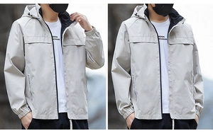 Detail of light gray hooded windbreaker jacket with elastic cuffs and black zipper