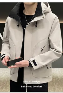 Detail of light gray hooded windbreaker jacket with functional pockets and modern fit