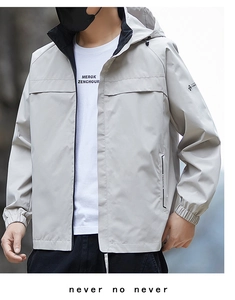 Detail of light grey windproof hooded jacket with drawstring and elastic cuffs