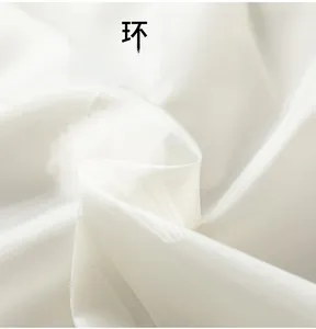 Detailed macro view of white breathable technical fabric with lightweight inner padding