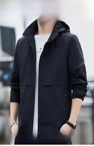 Detail of waterproof black windbreaker featuring sport lettering and adjustable hood