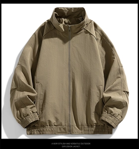 Detailed close-up of khaki outdoor jacket with stand collar and ripstop fabric texture