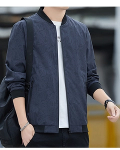 Detailed view of navy blue camouflage jacket with ribbed collar and zipper pockets