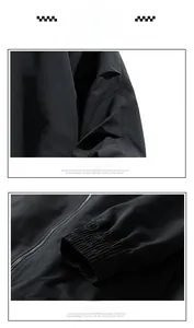 Detail of black windproof jacket featuring pleated patchwork sleeves and elastic cuffs