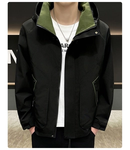 Detail of windproof hooded jacket with high collar and contrast green lining