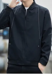 Detailed view of black bomber jacket featuring white contrast stitching and ribbed collar