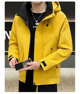 Detailed view of yellow windproof hooded jacket with contrasting black collar lining