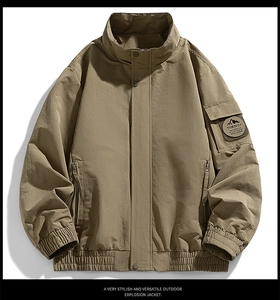 Detailed view of the olive green outdoor jacket with embroidered arm badge and ribbed cuffs
