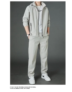 Close-up of a light grey men's sports tracksuit with a zip jacket and casual trousers