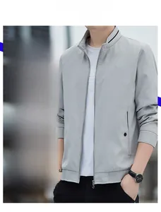 Detail of grey stand-collar jacket featuring metal zipper and ribbed cuffs for men