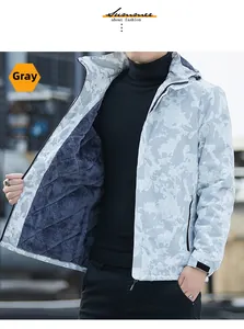 Detail of windproof jacket showing grey camouflage print and warm polar fleece lining