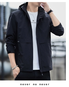 Detail of windproof cuff and zipper on men's black hooded outdoor jacket with urban look