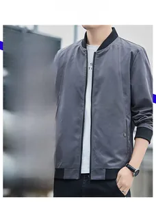 Detail of dark grey slim cut bomber jacket featuring ribbed stand collar and metallic zipper
