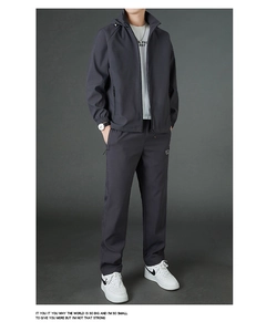 Detail of premium grey men's hooded sports jacket and pants set with windproof fabric