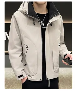 Detail view of water-resistant light gray jacket with large flap pockets and hood