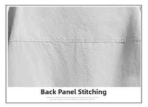 Detailed close-up of the back stitching and seam construction on a white outdoor jacket