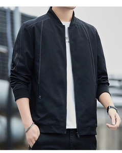 Detail of men's black bomber jacket featuring white contrast stitching and sleeve branding