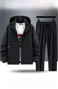 Detail view of waterproof and breathable black outdoor hiking jacket and pants set