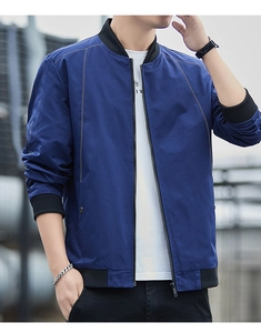 Detail of dark blue bomber jacket featuring white contrast stitching and ribbed collar