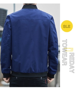 Detail view of navy blue bomber jacket back showing windproof fabric and ribbed hem