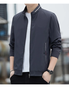 Detail of grey men's jacket with striped stand collar and functional zip pockets