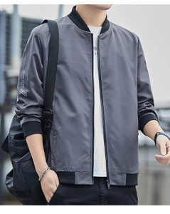 Detail of grey bomber jacket showing white contrast stitching and elastic ribbed cuffs