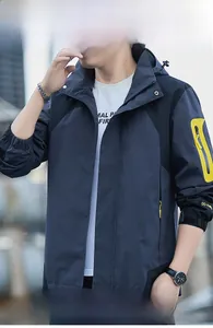 Detail of waterproof hooded outdoor jacket with windproof fabric and contrast zipper pocket