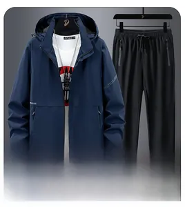 Detail of navy hooded outdoor jacket and black pants set with windproof fabric