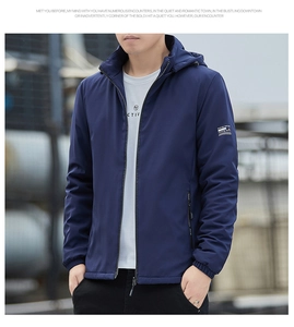 Detail of navy blue hooded jacket with metal zipper and elastic cuffs for wind protection