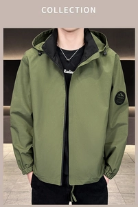 Detail of olive green hooded jacket featuring drawstring hood and mountain arm patch
