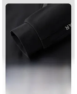 Close-up of ribbed cuffs on a black sports jacket showing fabric texture and quality stitching