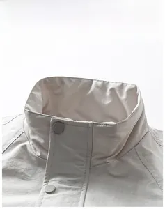 Detail of windproof stand collar and metallic snap buttons on casual outdoor jacket