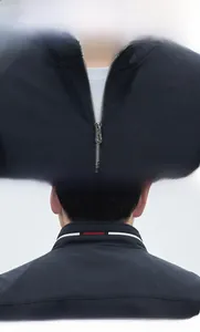 Detailed view of the sleek stand collar and metallic zipper on dark blue jacket