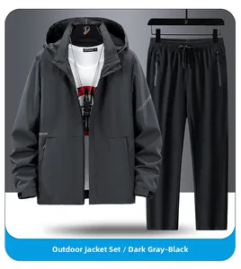 Detail of dark gray outdoor men's windbreaker jacket and black athletic pants set
