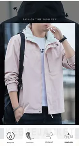 Detail of light pink waterproof windbreaker showing zipper pocket and adjustable hood