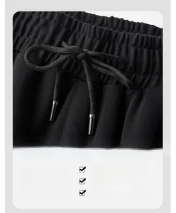 Close-up of elastic waistband with drawstring on men's black sports tracksuit jacket